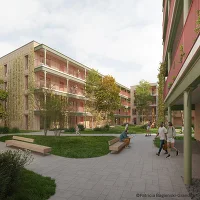 Wohnhausanlage mit Blick in den begrünten Innenhof und Personen