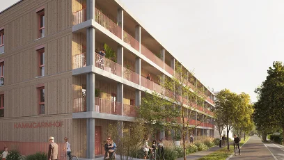 Wohnhausanlage mit Grünfläche und Fahrradweg und Menschen